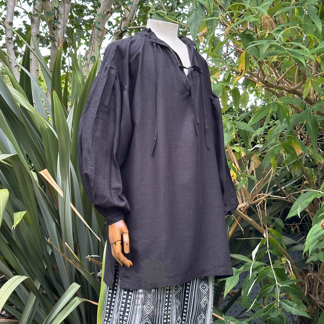 Black cotton-linen medieval shirt with ties, side view.