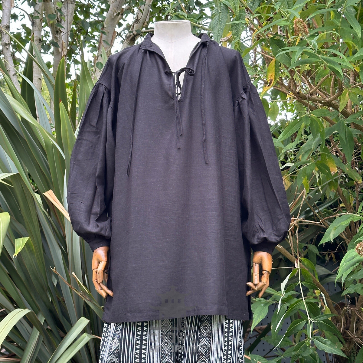 Black LARP shirt with long sleeves and tie neck, displayed on a mannequin.