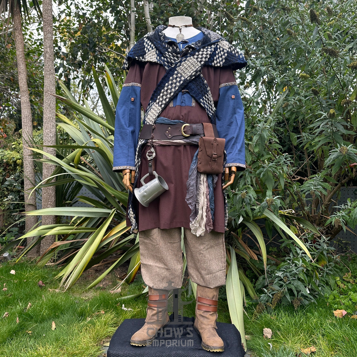 LARP outfit with blue tunic, belt accessories, and crisscrossed scarf.