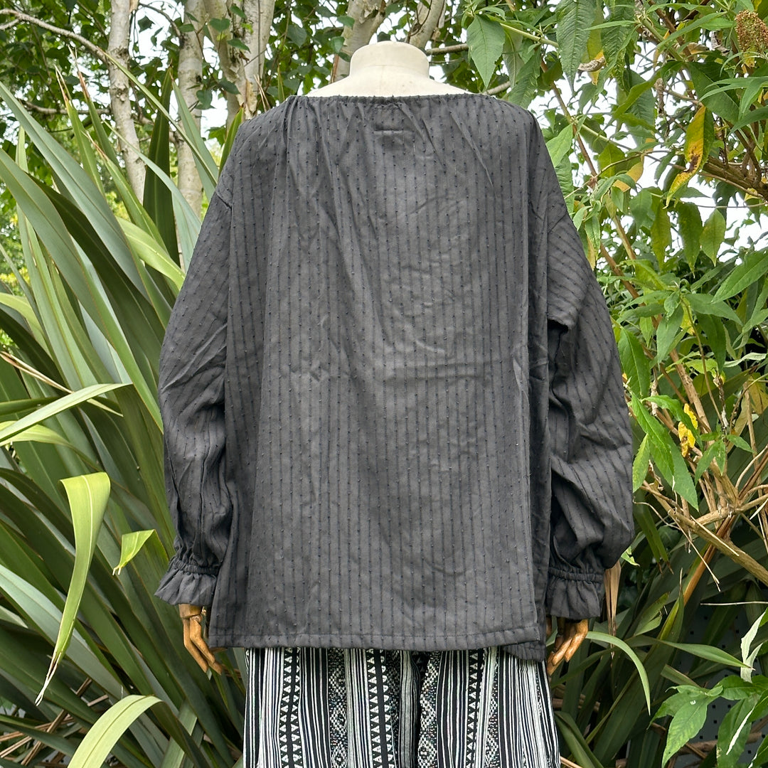Rear view of black cotton medieval LARP shirt with round neck.