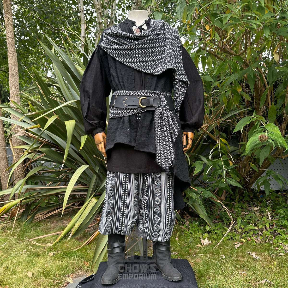 Medieval noble LARP outfit with black robe, patterned pants, scarf.