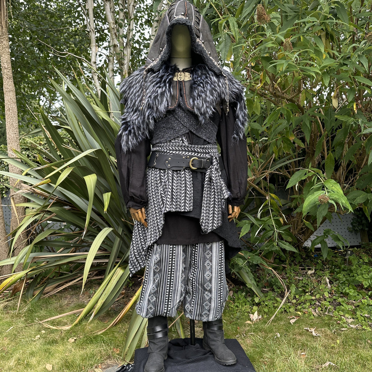 Medieval LARP costume front view, includes faux leather hood, black and white waistcoat with.
