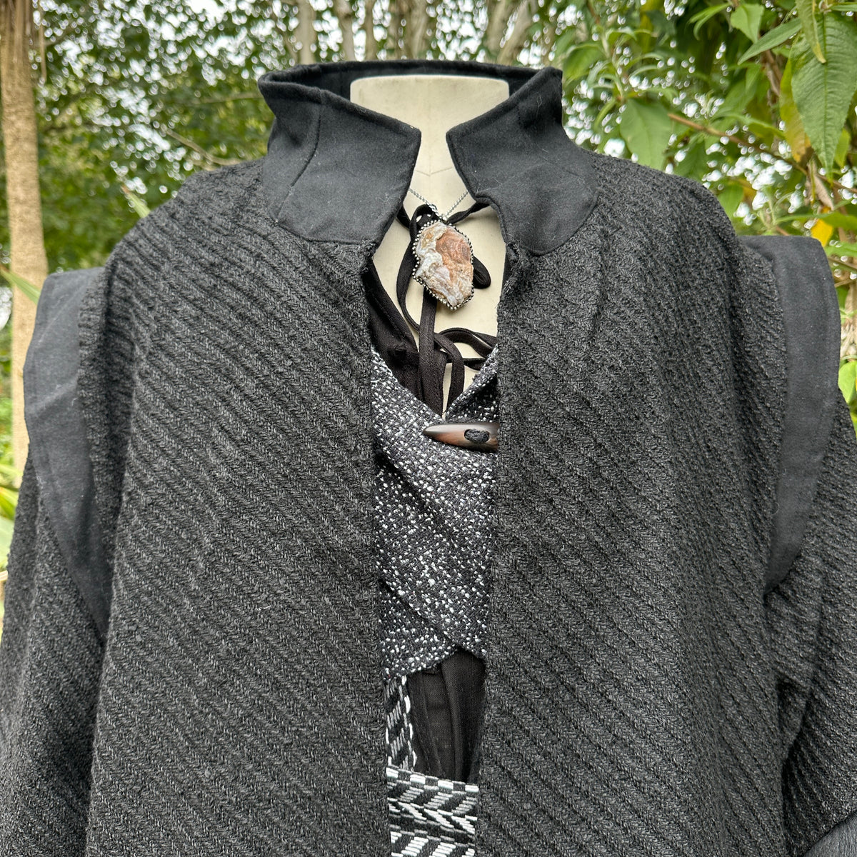 Close-up of high collar and shoulder detailing on black wool medieval LARP robe, fantasy cosplay.