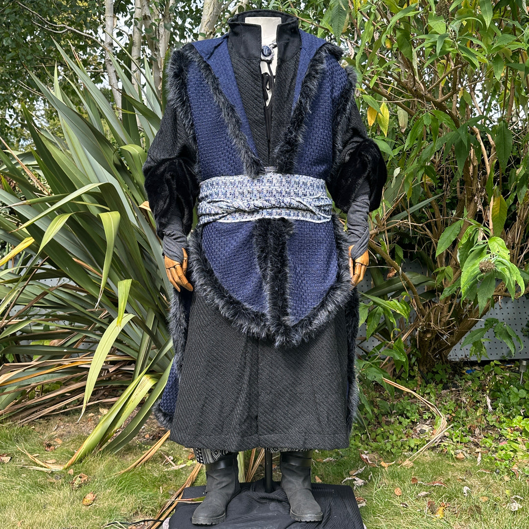 Full-length view of blue and black fur-trimmed Viking LARP cape, authentic medieval fantasy.