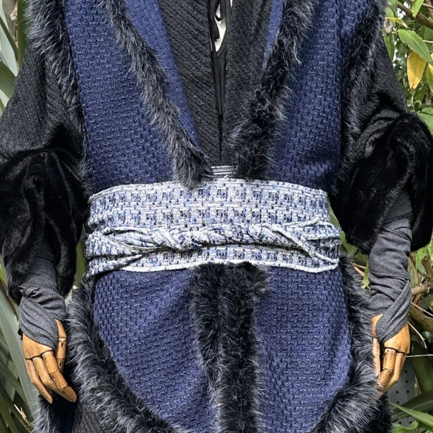 Blue knitted LARP sash and belt, white pattern, buffalo leather trim.