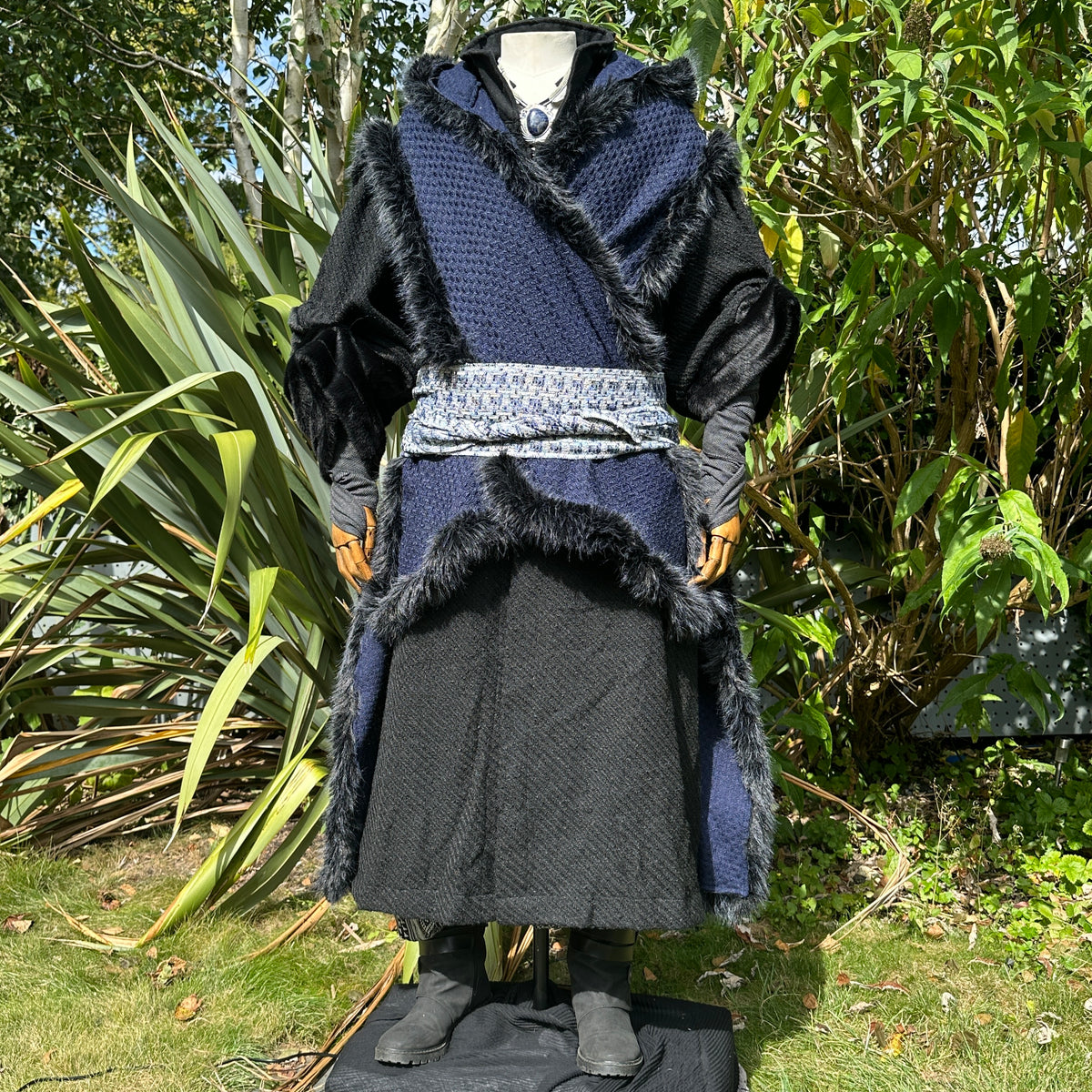 Blue and black Viking LARP cape styled over tunic and belt, medieval fantasy cosplay costume for.