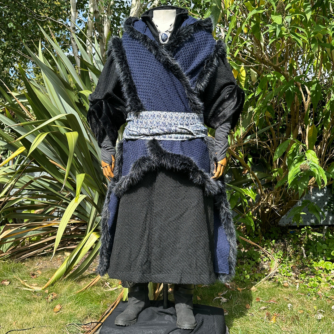 Blue and black Viking LARP cape styled over tunic and belt, medieval fantasy cosplay costume for.