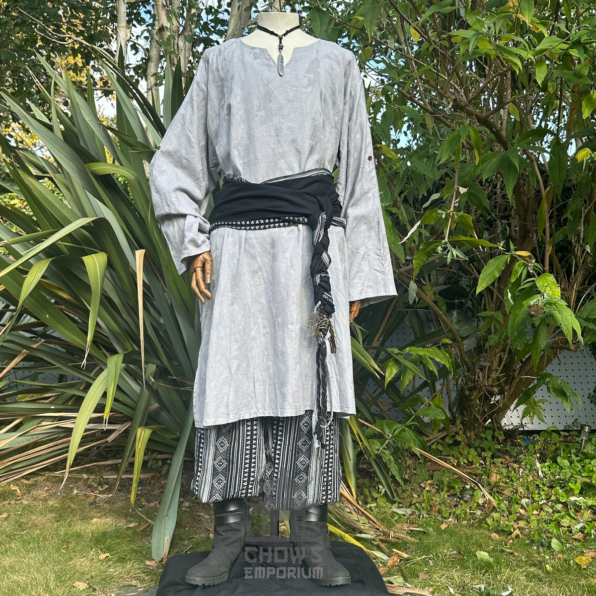 Medieval LARP outfit front view, featuring a grey tunic, black and white trousers and matching sash.