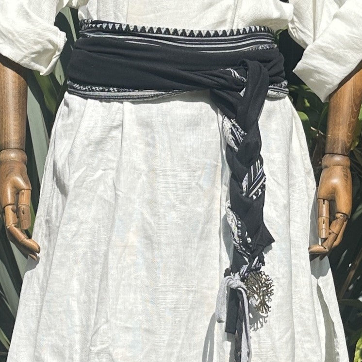 White tunic, black sash LARP medieval outfit, close-up fabric detail.