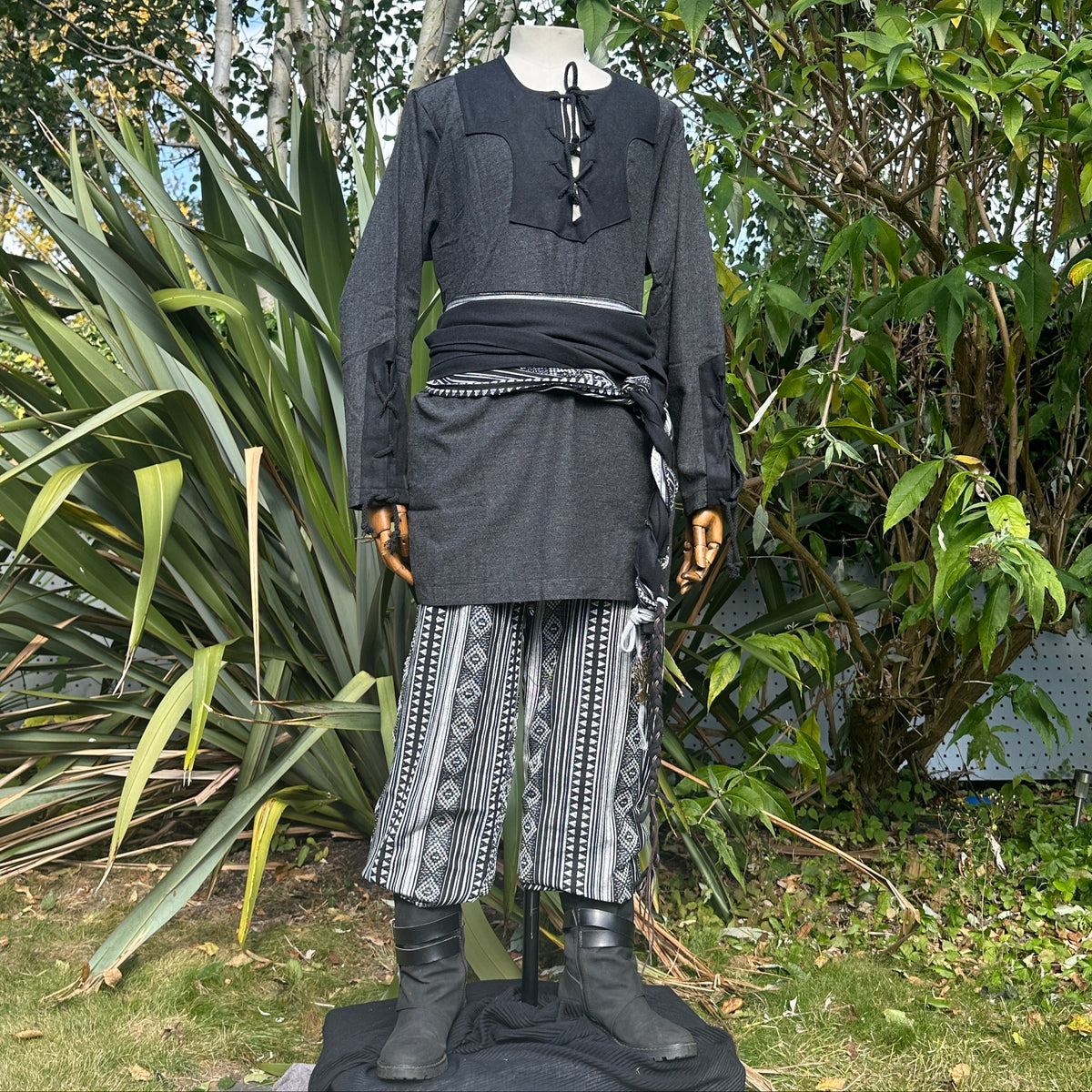 Black medieval shirt, patterned trousers, and sash for LARP, side angle.
