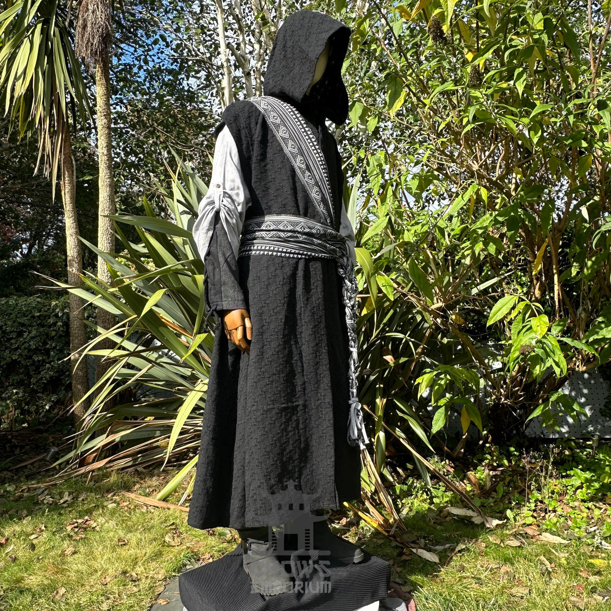 Angled view of black sleeveless medieval LARP robe, fantasy cosplay costume with hood and.