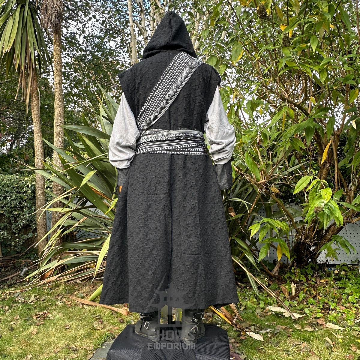 Back view hood up. Black sleeveless LARP robe styled over tunic and belt, medieval fantasy.