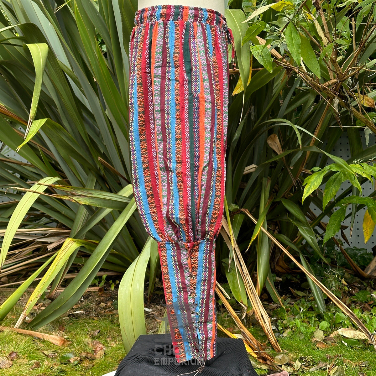 Side view of multi-color cotton LARP trousers with calf lacing and braid detail no boots.