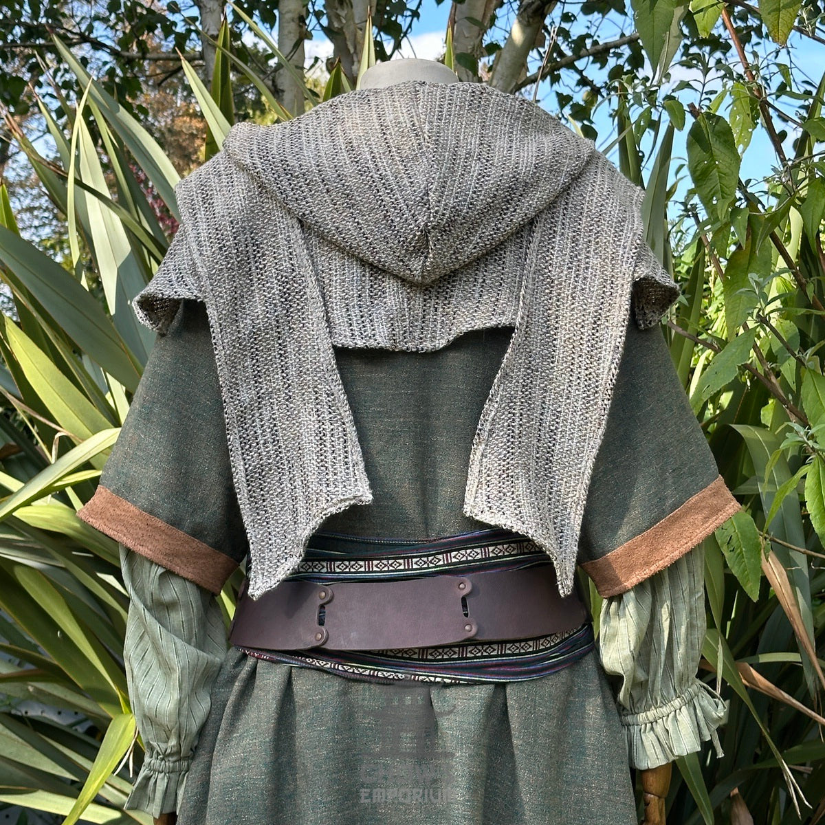 Back view of a green medieval LARP tunic with a grey knitted hood and sash.