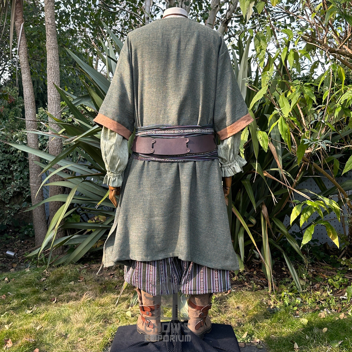 Back view of green and brown woven medieval LARP tunic with belt.