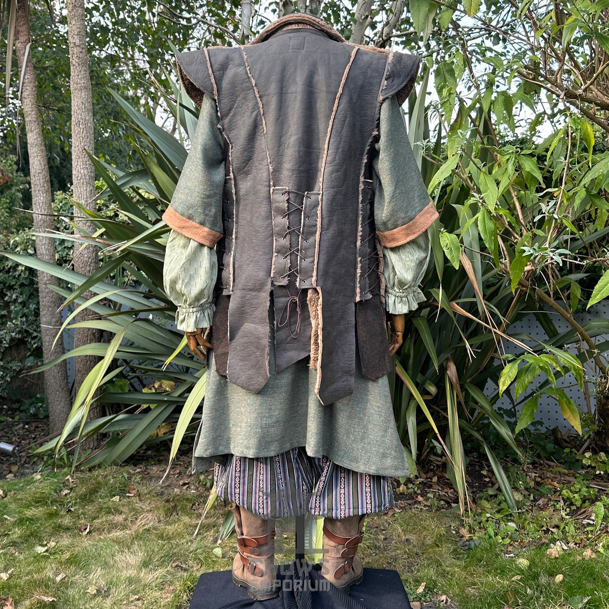 Medieval LARP outfit back view, featuring a green faux leather waistcoat, tunic, trousers and sash.