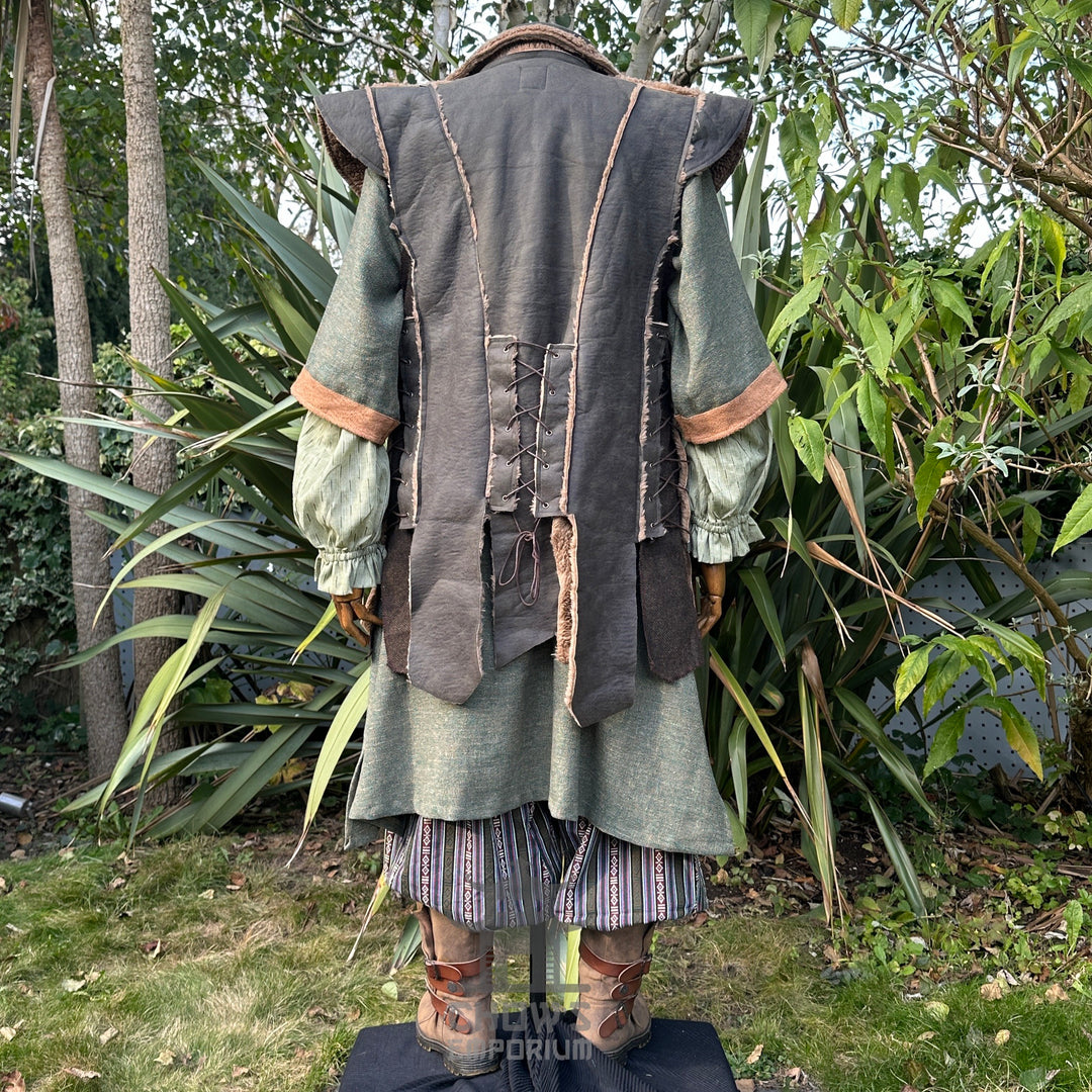 Medieval LARP outfit back view, featuring a green faux leather waistcoat, tunic, trousers and sash.