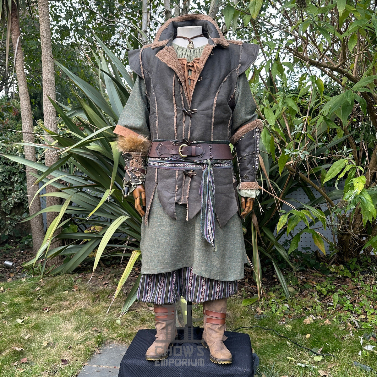 Forest Fighter LARP outfit with green tunic, textured waistcoat, sash, and striped trousers.