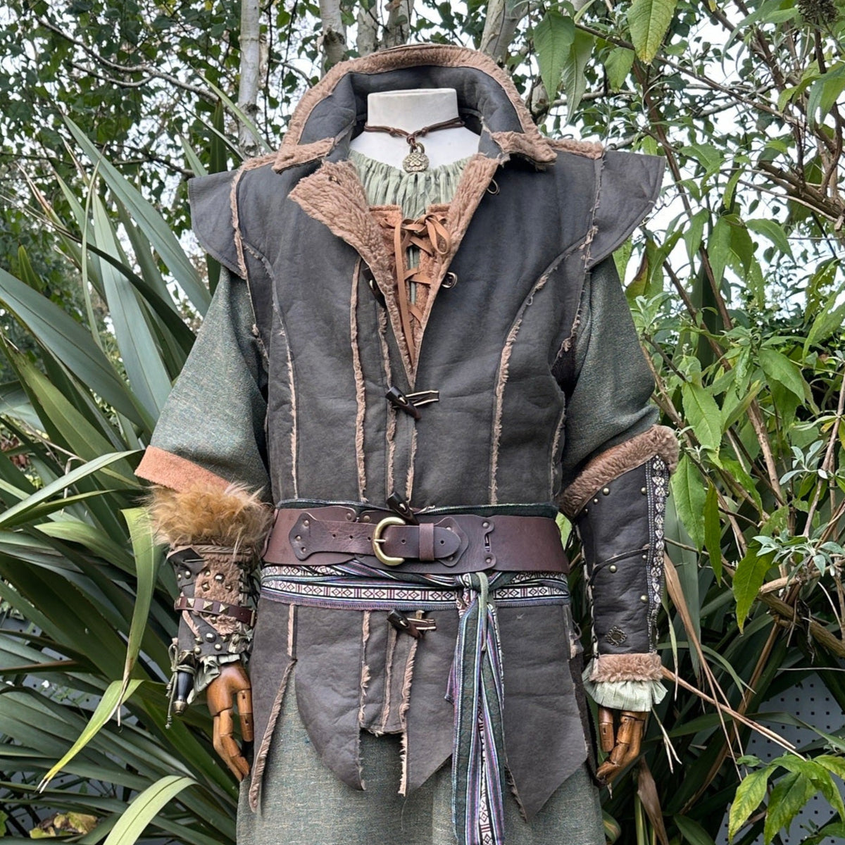 Green and brown faux leather LARP waistcoat with fur trim for medieval and fantasy cosplay.