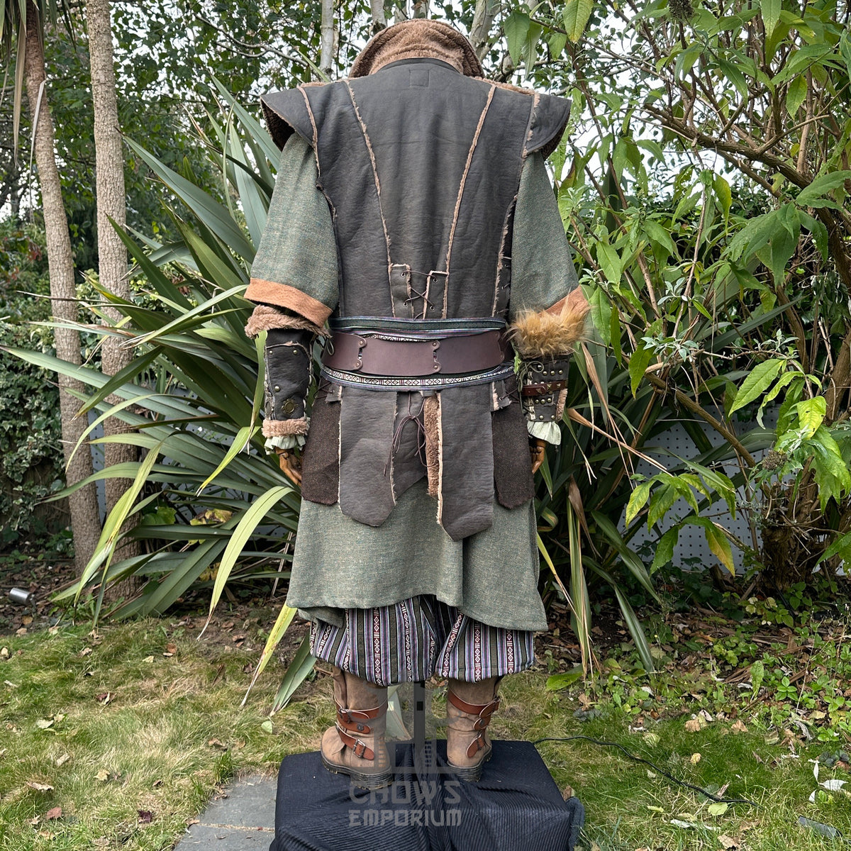 Forest Fighter LARP outfit rear view, green tunic, leather waistcoat, striped trousers.