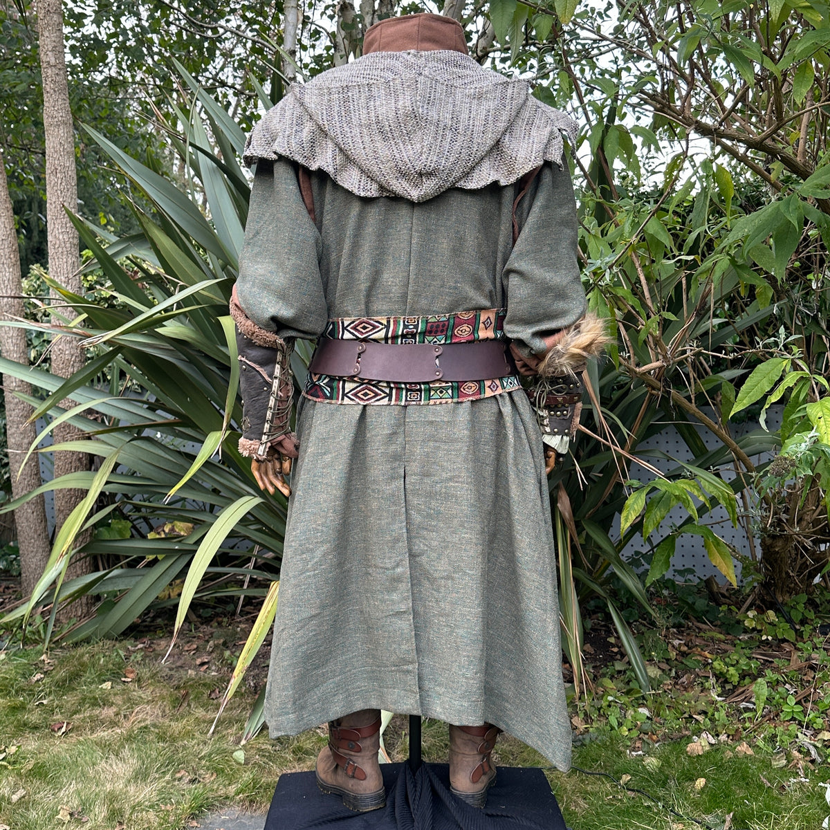 Medieval LARP costume back view featuring green robe, wool hood, vambraces, belt, sash and necklace.