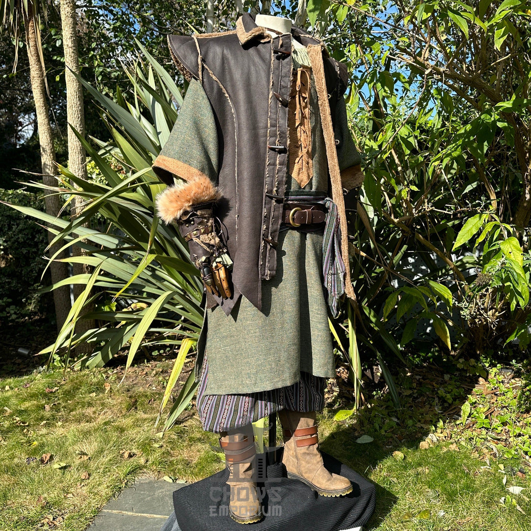 Medieval LARP outfit side view, featuring a brown waistcoat, green tunic, trousers and sash.