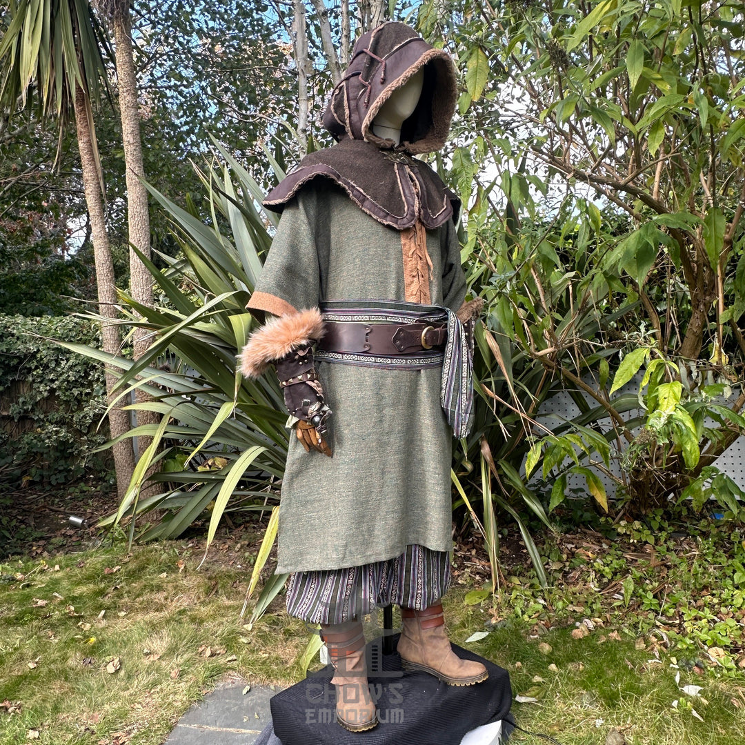 Green and brown woven medieval tunic for LARP, side view, natural setting.