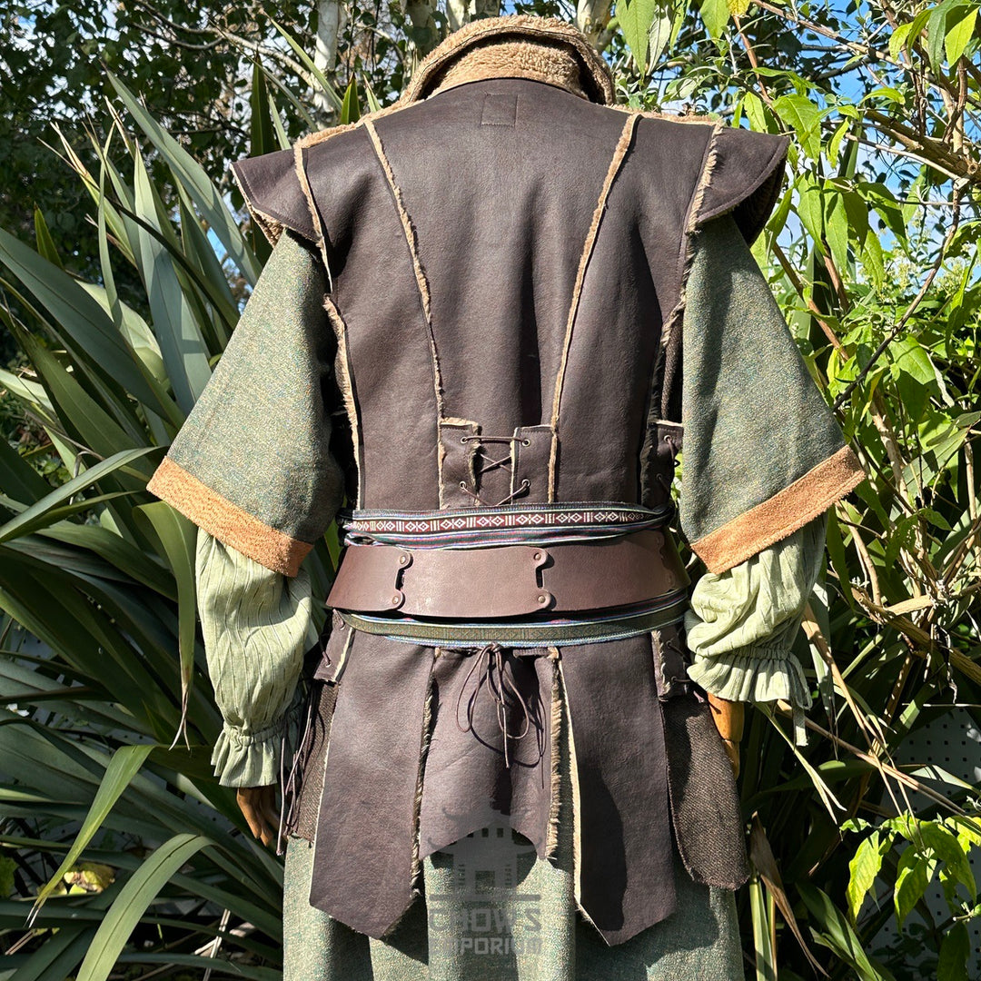 Back view of LARP ranger set: brown leather waistcoat, green tunic, foliage backdrop.