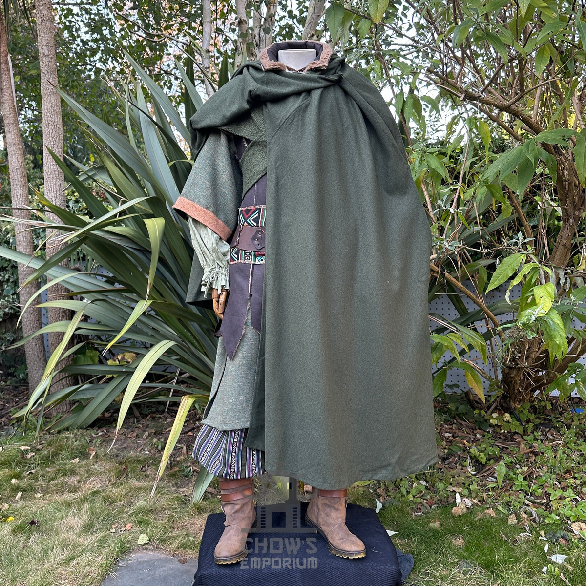 Medieval LARP outfit with green cloak, waistcoat, hood, side view.
