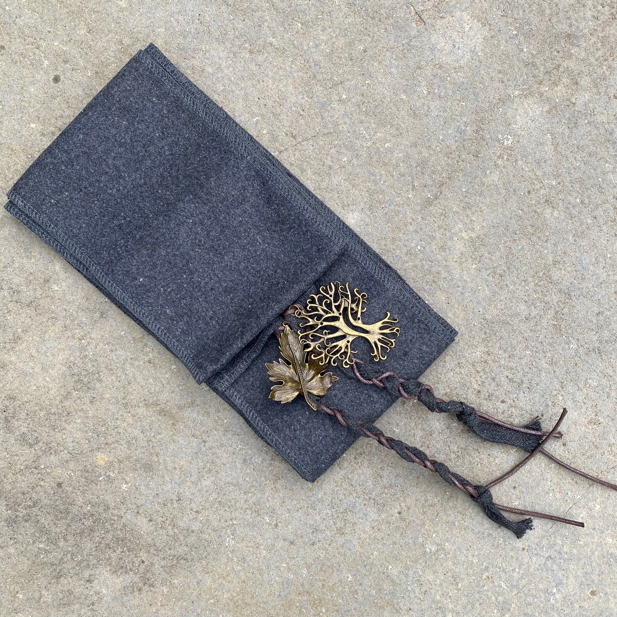 Medieval grey sash with brass leaf charms for LARP costume detail.