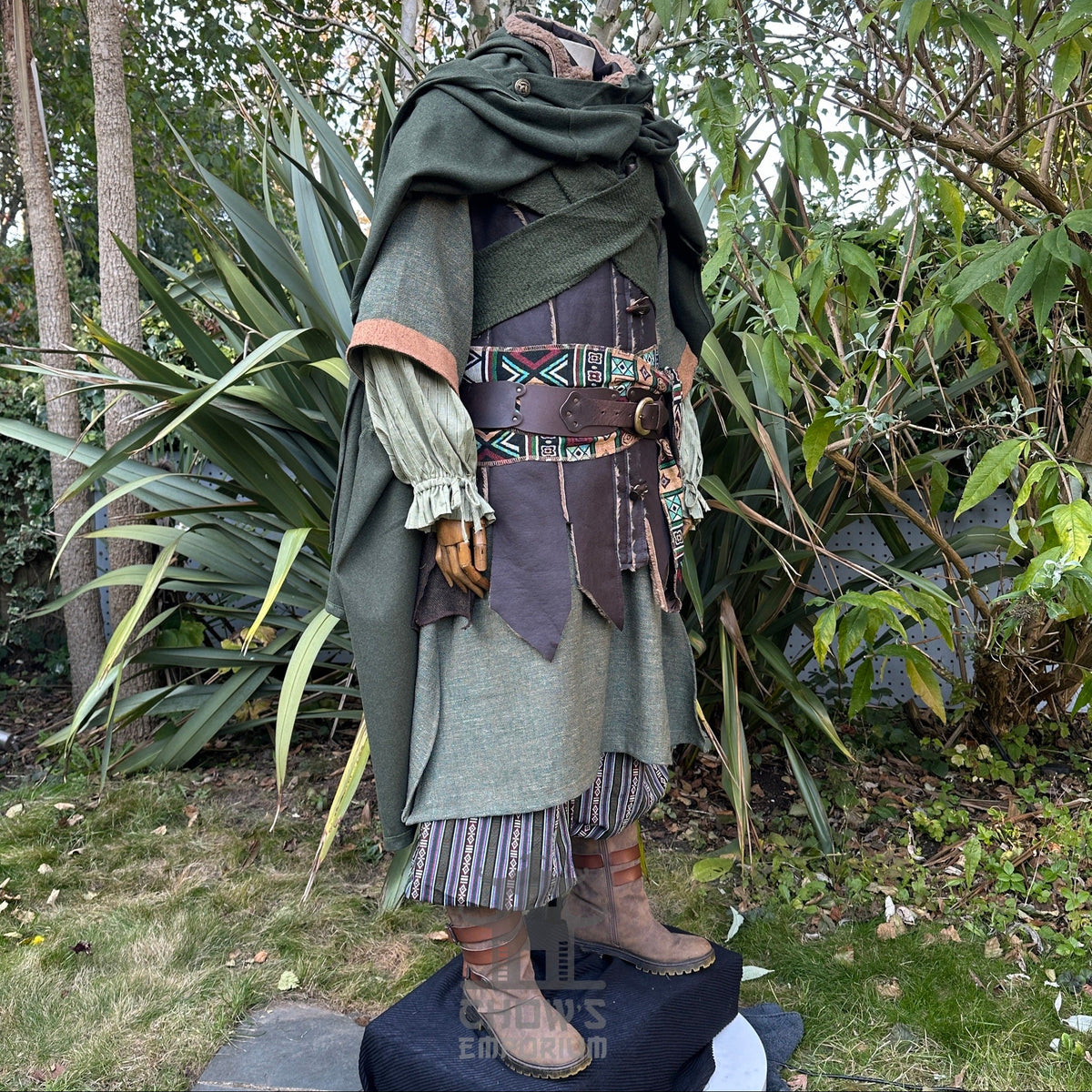 Medieval LARP outfit side view, featuring a green cloak, waistcoat, hood, shirt, trousers, belt.