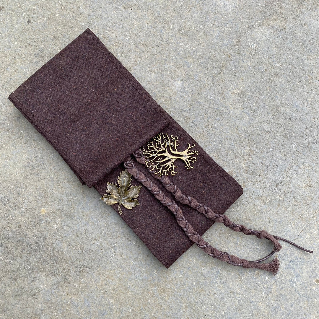 Medieval LARP wrap set close-up; braided tassels and leaf detail on fabric.