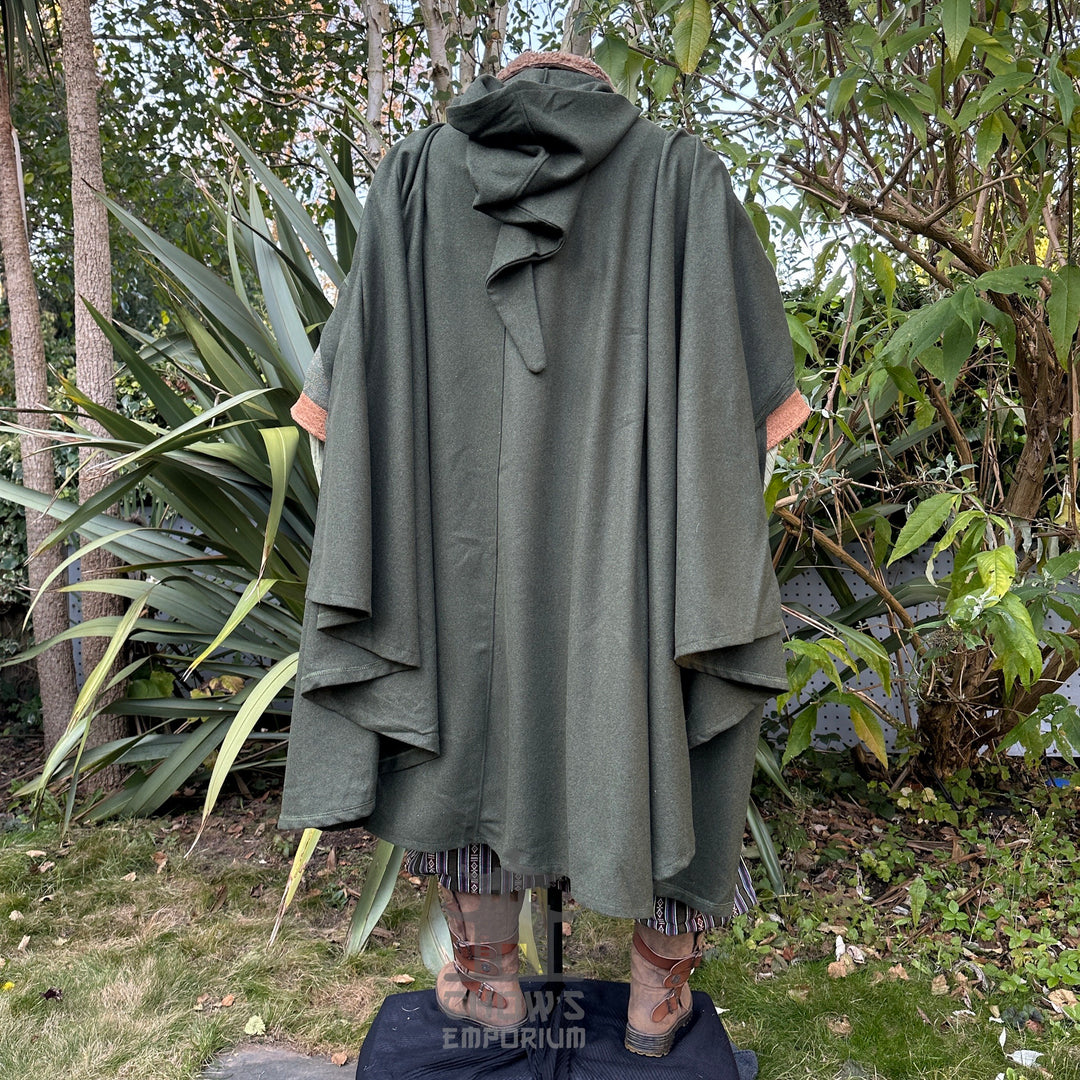 Cloaked forest ranger from behind, in a green medieval LARP setting.
