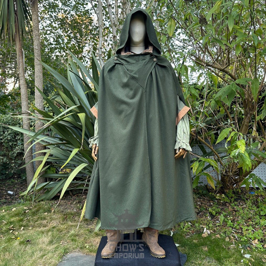 Hooded forest green medieval cloak in garden setting, detailed sleeve cuffs.