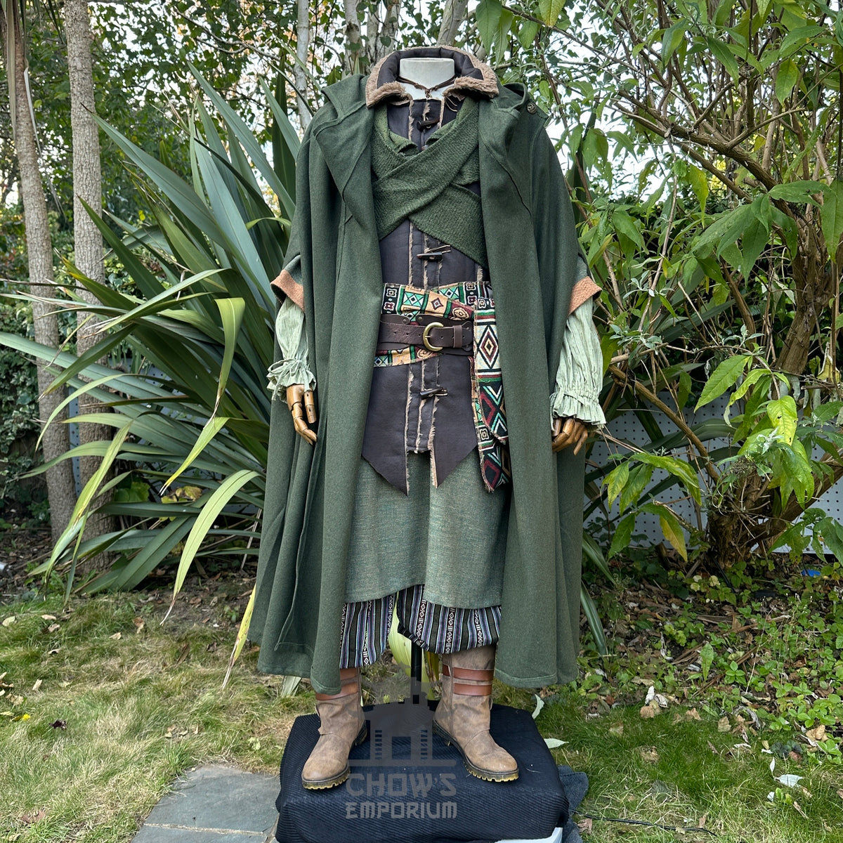 Medieval LARP outfit with green cloak and patterned sash.