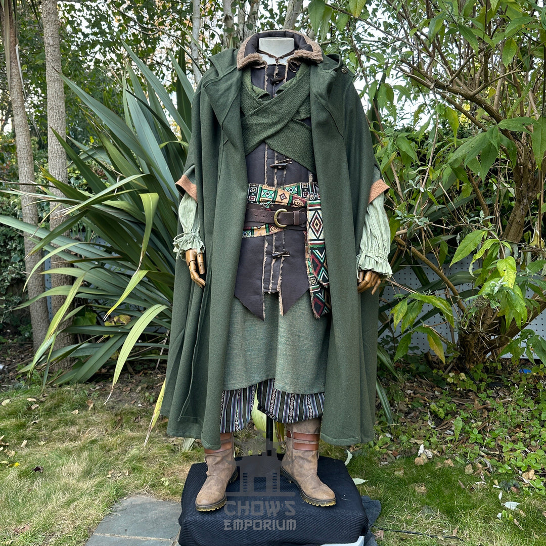 Medieval LARP outfit with green cloak and patterned sash.