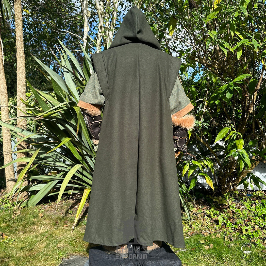 Back view of hooded green LARP robe with fur cuffs and lush forest backdrop.
