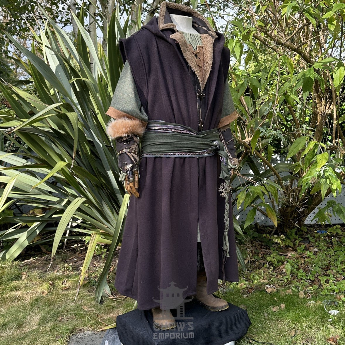 Medieval LARP outfit side view, featuring a brown hooded robe, vambraces, tunic, and sash.