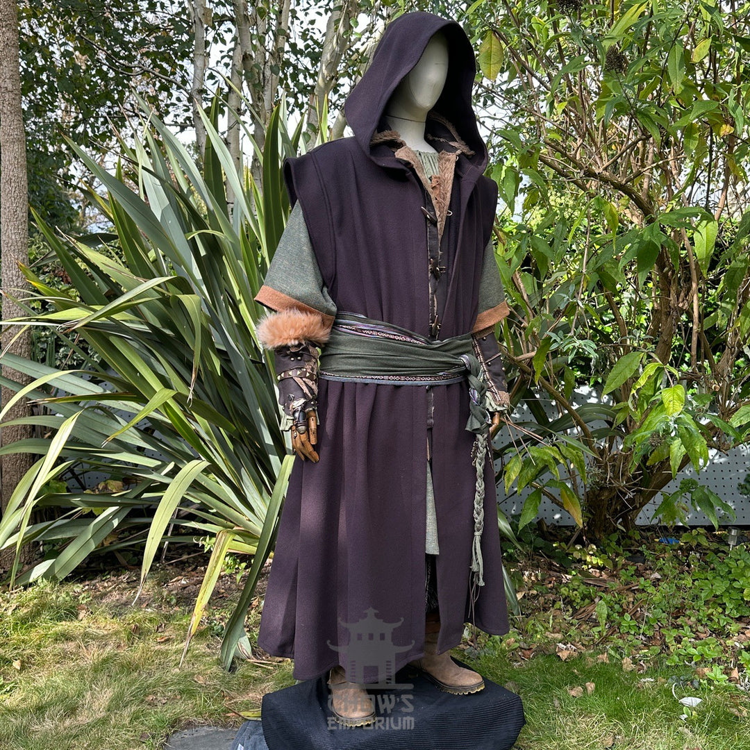 Medieval LARP outfit side view, featuring a brown hooded robe, waistcoat, vambraces, shirt.