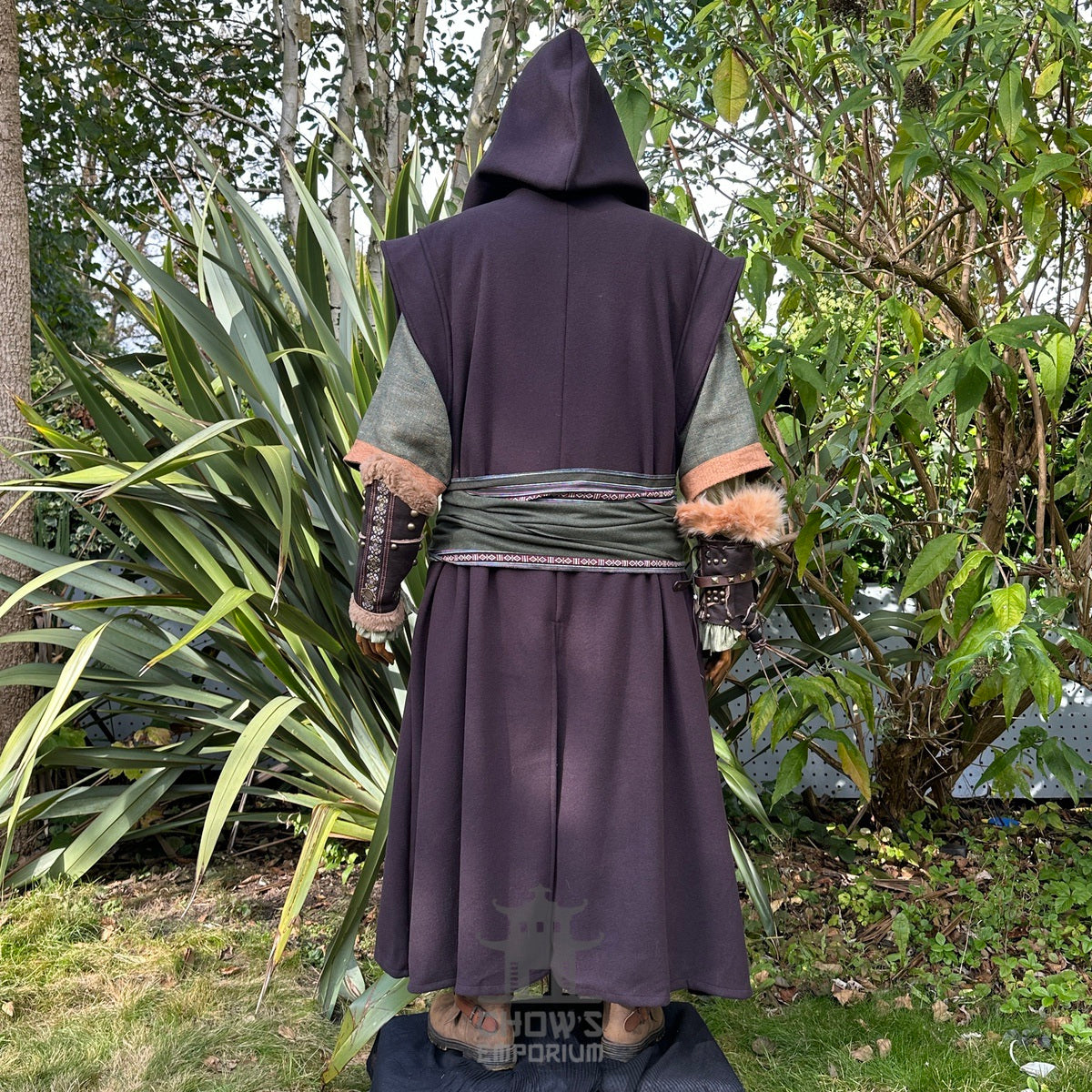 Medieval LARP outfit back view, featuring a brown hooded robe, waistcoat, vambraces, shirt.