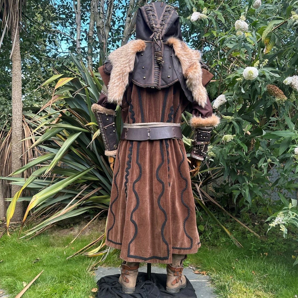 Rear view of a brown medieval LARP outfit with fur hood and long waistcoat.