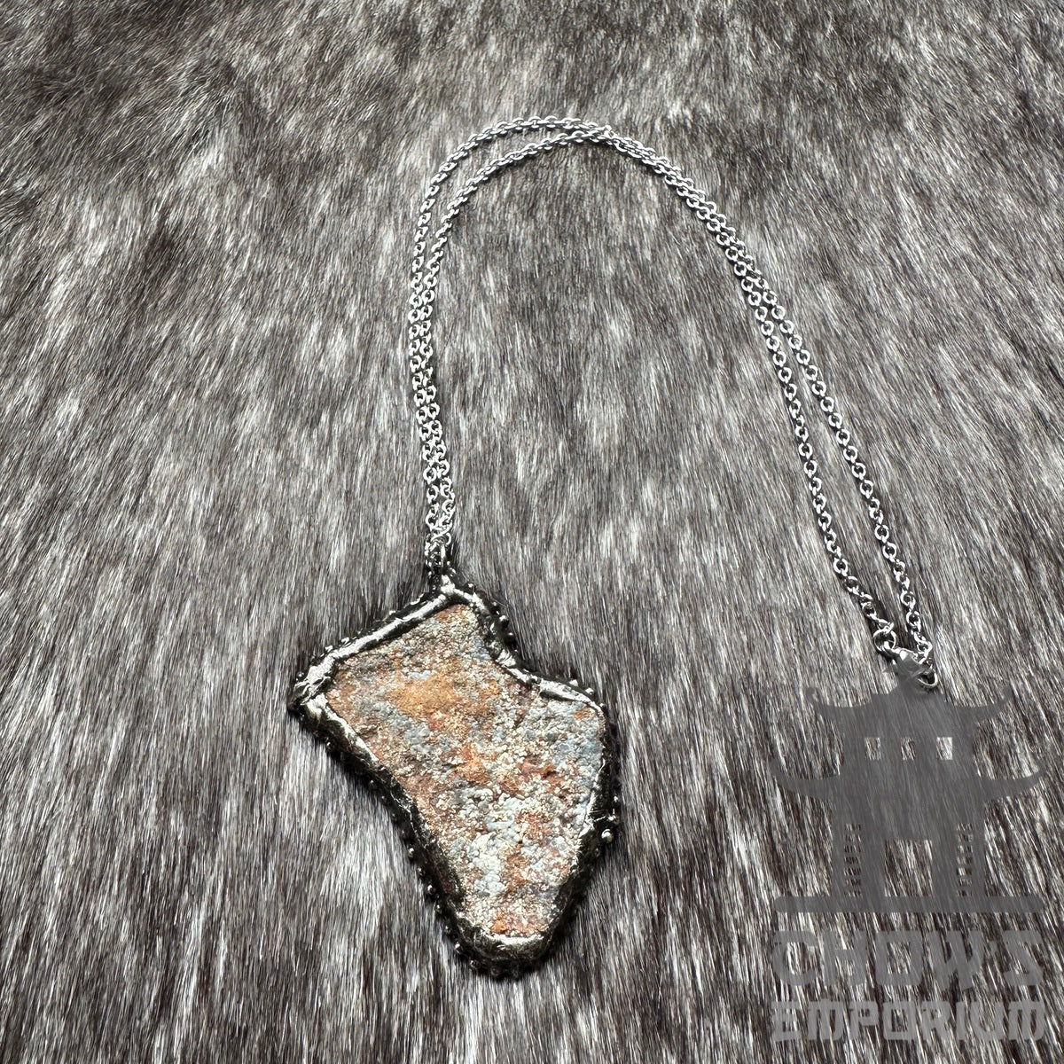 Medieval LARP crystal quartz necklace on silver chain, fur background.