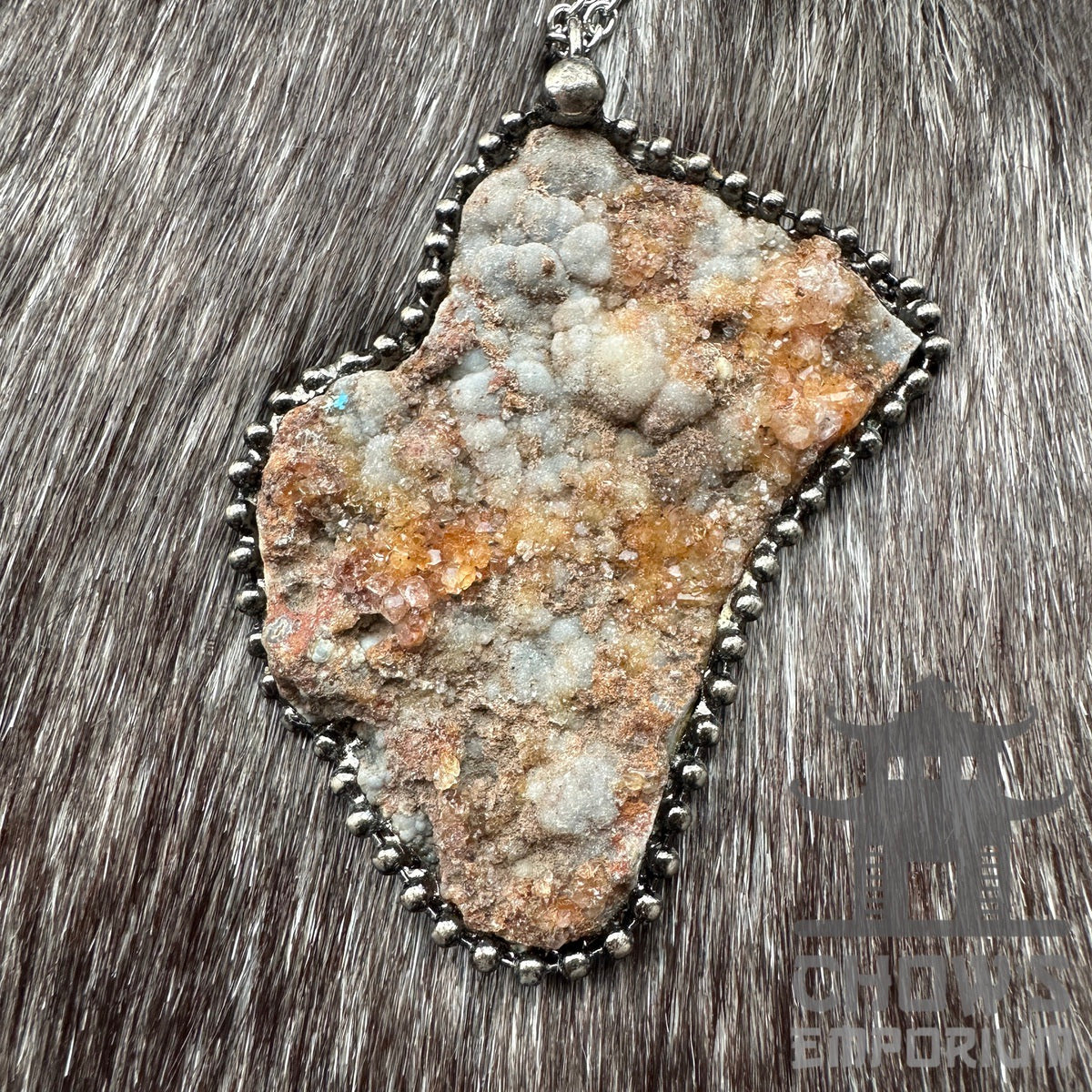 Crystal quartz necklace with metal frame on fur background for LARP.