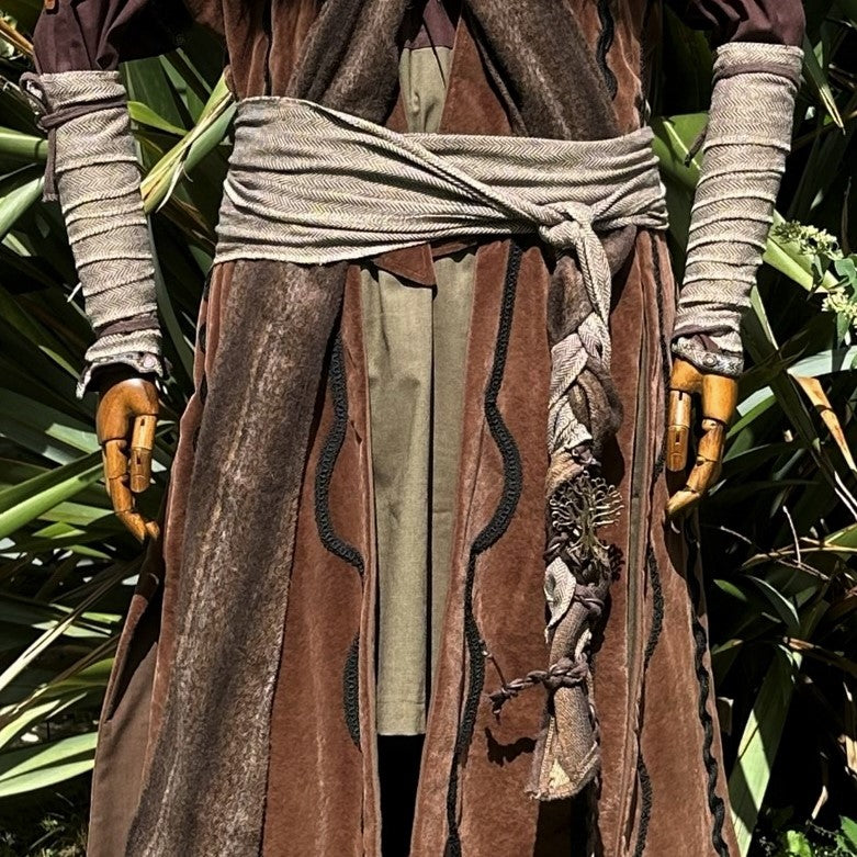 LARP medieval wrap set with light brown herringbone sash tied at waist.