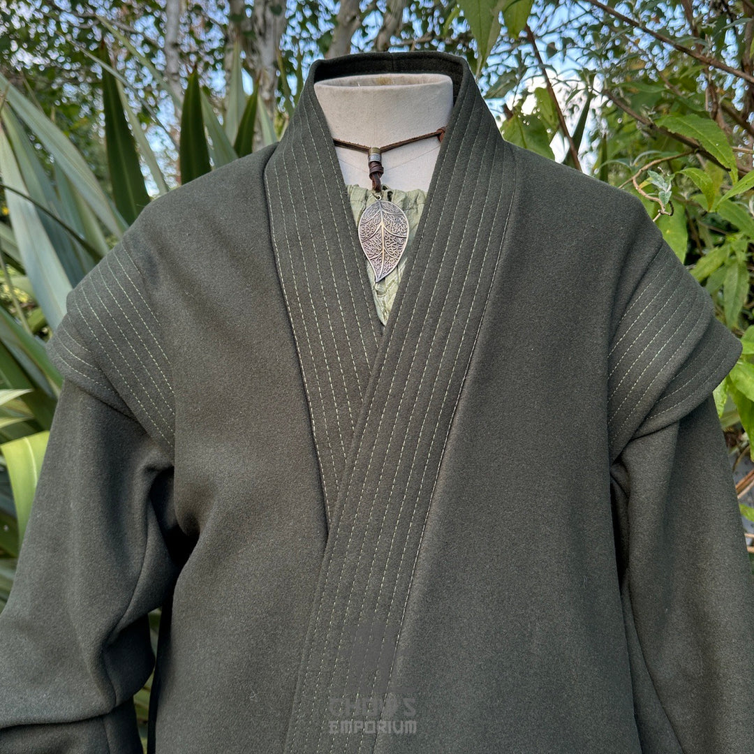 Close-up of green herringbone fabric from medieval LARP robe, textured fantasy cosplay costume.
