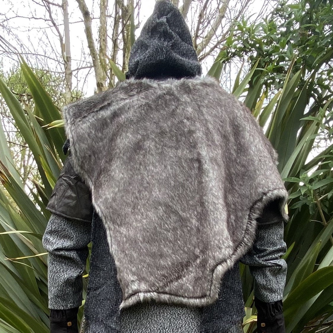 Medieval LARP outfit back view, featuring a grey wrap-around hood, and grey faux-fur mantle.