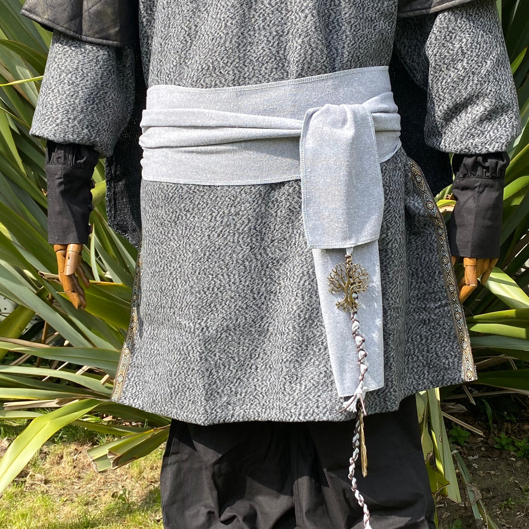Grey medieval LARP jacket, hood with sash detail and black arm wraps, rear view.