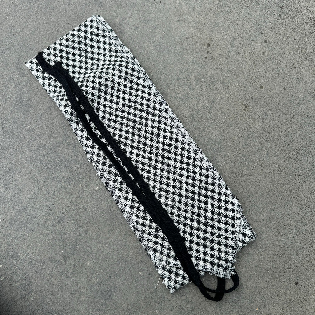 Black and white checkered wool leg wraps for LARP or medieval outfit.