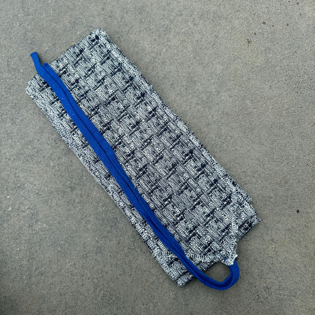 Blue and white knitted LARP sash displayed lying flat.