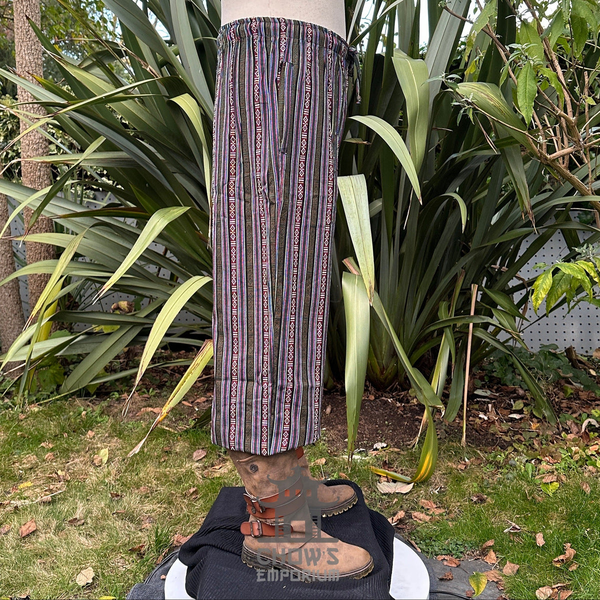 Side view of medieval LARP pants with striped pattern and boots.